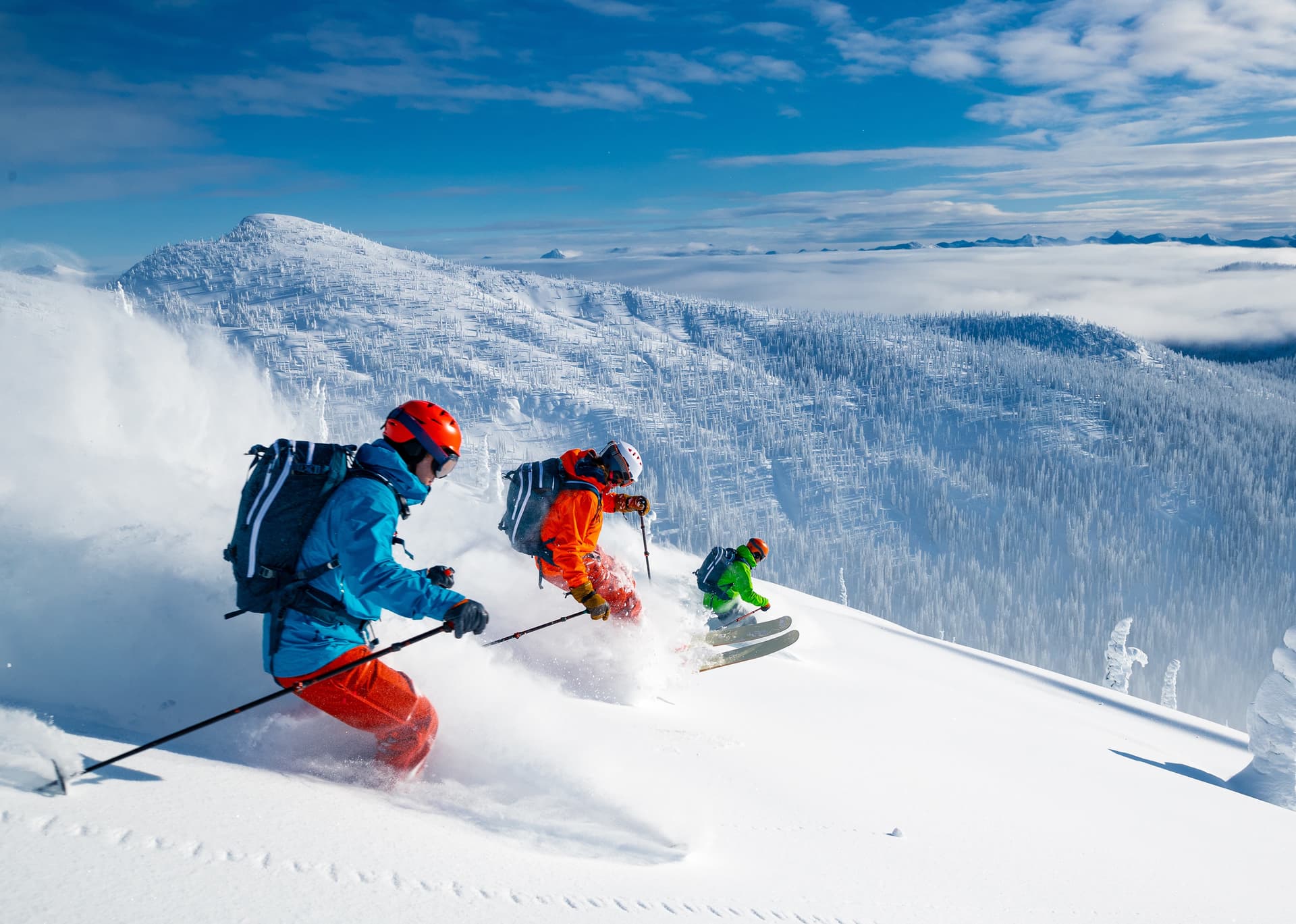 skiers race down a mountain with powder trails